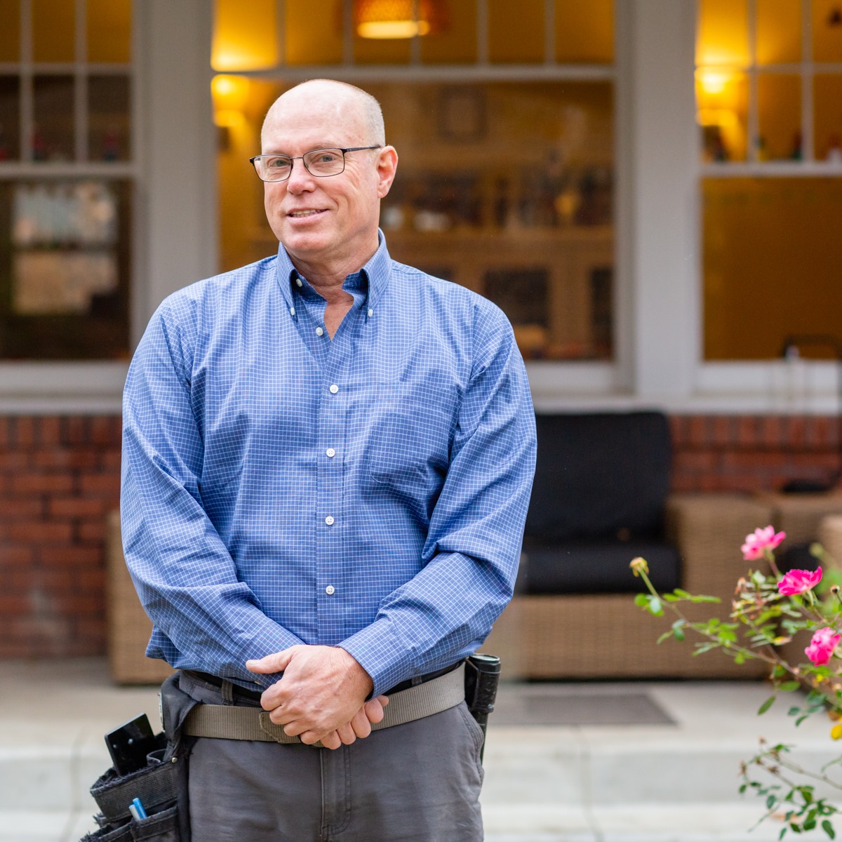 David Thompson, home inspector, standing in front of a home